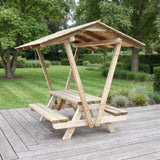Gartenholz.org pressure-treated wooden picnic table with a protective roof and integrated benches on a patio.